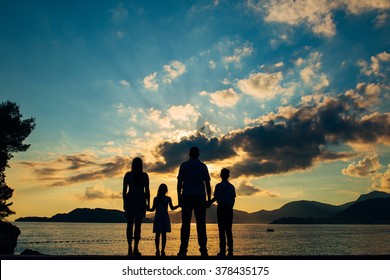 Family Silhouette In The Sunset