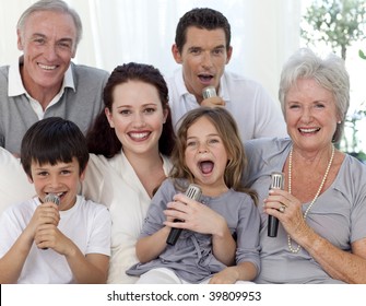 Family Singing Karaoke With Microphones At Home