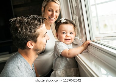 Family Sit Near Window On The Livingroom