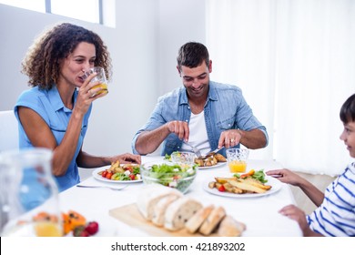 Family Sitting At Breakfast Table In Dinning Room