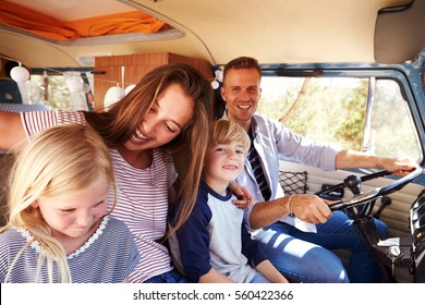 Family Sitting At The Front Of Their Camper Van, Dad Driving