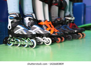 Family Sitting On Couch At Roller Skating Rink