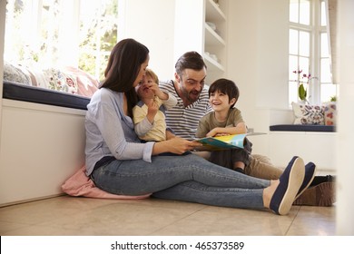 Family Sitting On Floor Reading Story At Home Together - Shutterstock ID 465373589