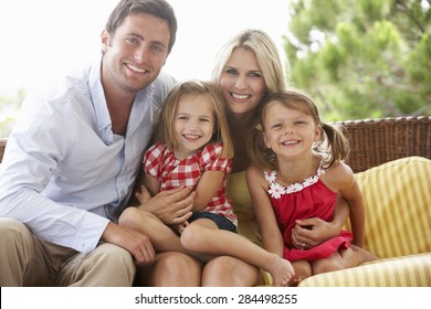 Family Sitting On Garden Seat Together - Shutterstock ID 284498255