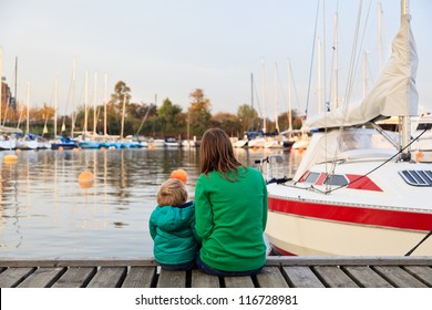 Family Sitting On Pier