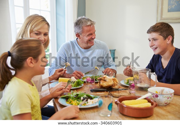 Family Sitting Table Enjoying Meal Home Stock Photo 340603901 