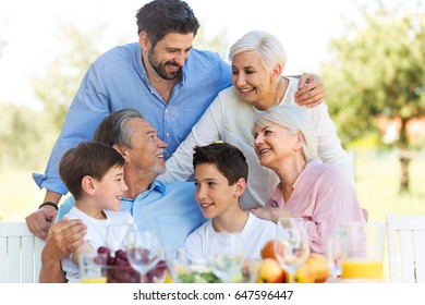 Family Sitting Table Outdoors Smiling Stock Photo 647596447 | Shutterstock