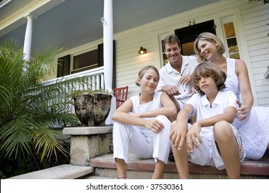 Family Sitting Together On Front Porch Steps