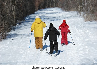 Family Skiing On Trail