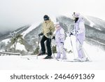 Family skiing in the snow, parents and daughter