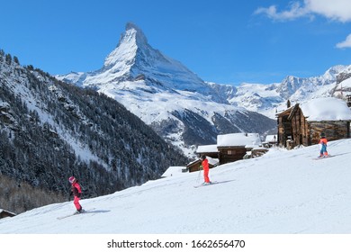 Family Skiing In Zermatt, Switzerland. The Matterhorn. Family Vacation. Swiss Alps Winter.