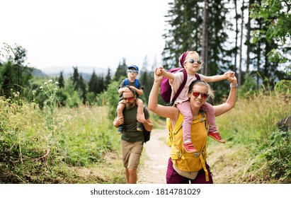 Family with small children hiking outdoors in summer nature. - Shutterstock ID 1814781029