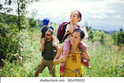 Family With Small Children Hiking Outdoors In Summer Nature.