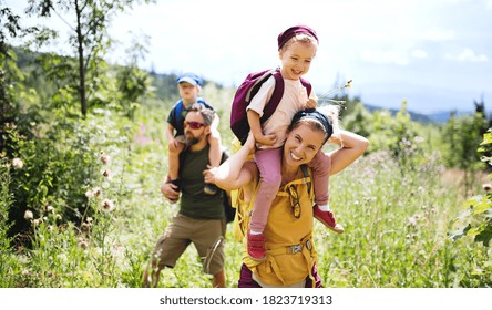 Family with small children hiking outdoors in summer nature. - Shutterstock ID 1823719313