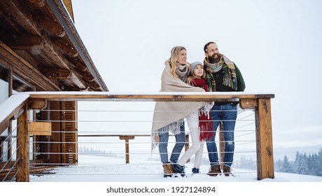 Family With Small Daughter On Terrace Outdoors, Holiday In Winter Nature.