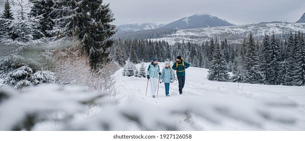 Family With Small Daughter On A Walk Outdoors In Winter Nature, Tatra Mountains Slovakia.