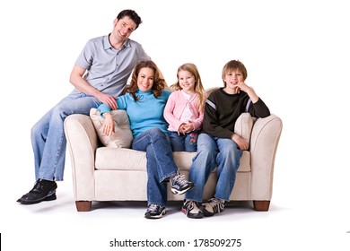 Family: Smiling Nuclear Family Sitting On Couch