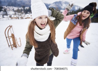 Family Snowball Fight In Winter 
