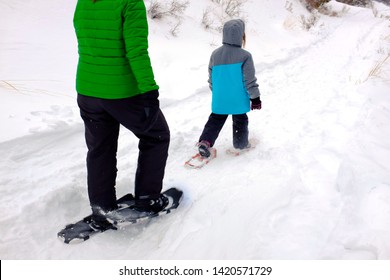 Family Snowshoeing In The Winter Snow Outdoors Kids Having Fun