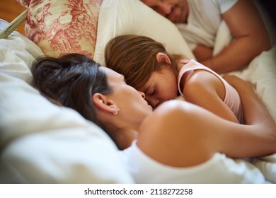 Family Snuggle Time. Shot Of A Family Sleeping In Bed At Home.