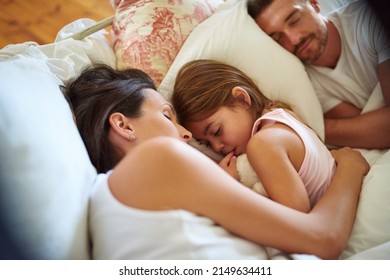 Family Snuggle Time. Shot Of A Family Sleeping In Bed At Home.