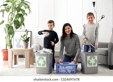 Family Sorting Garbage At Home. Concept Of Recycling