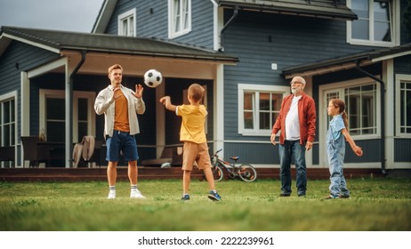 Family Spending Leisure Time Outside with Kids, Grandfather Playing with Ball with a Children. People Throwing the Ball Between Each Other, Having Fun on a Lawn in Their Front Yard. - Powered by Shutterstock