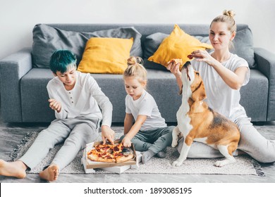 Family spending time together and eating pizza at home. - Powered by Shutterstock