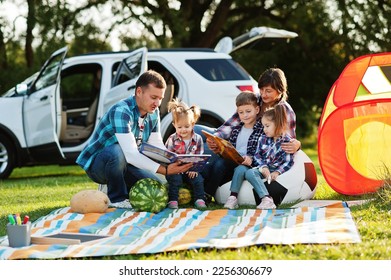 Family spending time together. Three kids. Outdoor picnic blanket. - Powered by Shutterstock