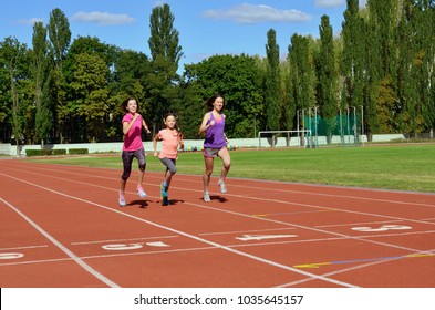 Family Sport And Fitness, Happy Mother And Kids Running On Stadium Track Outdoors, Children Healthy Active Lifestyle Concept