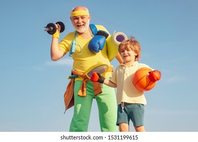 Family Sport. Grandfather And Grandson With Basketball Ball And Yoga Mat In Hands. Senior Man And Child In Family Health Club