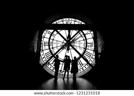 Family standing in front of a giant clock 