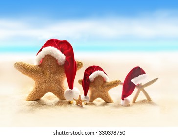 Family of starfish on summer beach and santa hat. Merry Christmas - Powered by Shutterstock