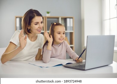 Family Staying At Home And E-learning Via Interactive Platform. Happy Smiling Mother And Child Waving Hands At Laptop Computer, Greeting School Teacher Or Private Tutor In Online Lesson Via Video Call