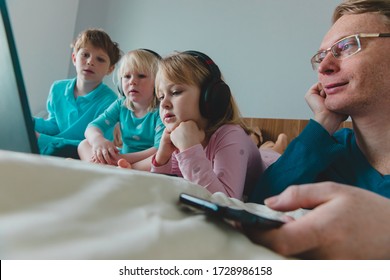 family staying home, father with mobile phone and kids with computers