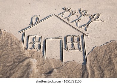 Family Of Stick Figures Standing On The Roof As Flood Waters Rush In Around Their House Drawn In The Sand