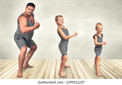  Family Of Strongman. The Father Of Two Sons In Vintage Costume Of Athletes Perform Strength Exercises. Family Look.