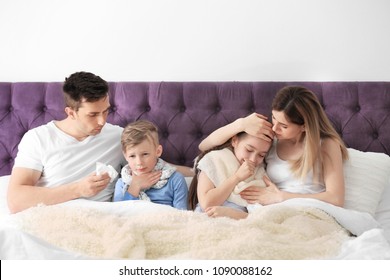 Family Suffering From Cold In Bed At Home