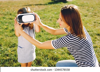 Family In A Summer Park. Mother With Children. Cute Little Girl In A Vr Glasses