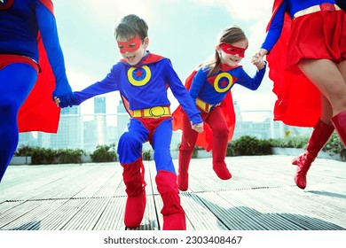 Family of superheroes running on city rooftop - Powered by Shutterstock