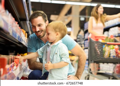 Family in the supermarket. Soft focus, high ISO, grainy image. - Powered by Shutterstock