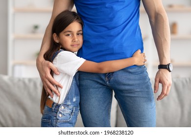 Family Support Concept. Closeup Portrait Of Sad Little Girl Hugging Her Father, Unrecognizable Man Comforting His Afraid Daughter. Abuse, Bullying, Victim, Fear And Danger