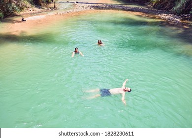 Family Swimming At The River