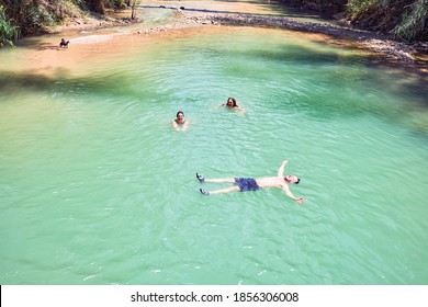 Family Swimming At The River