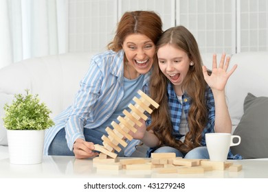 Family At The Table Playing Board Game