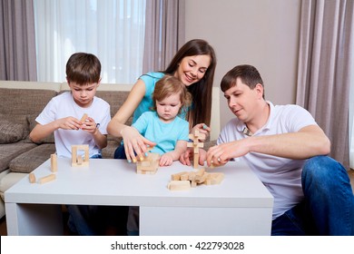 Family At The Table Playing Board Games.