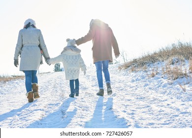 Family Takes A Winter Hiking Tour In The Snow