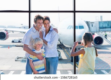 Family Taking Photo In Airport Departure Lounge