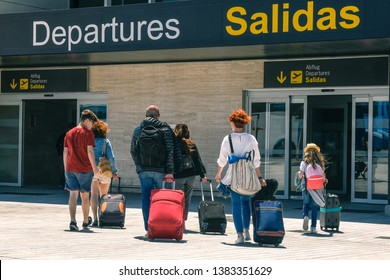 Family Taking A Plane. Friends Returning From Vacation Walk Sad At Airport Departures. Adults And Children Leaves Happy For Carefree Days Of Break. Group Of People Traveling With Holidays Luggages 