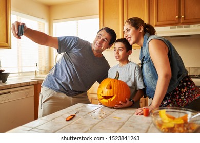 Family Taking Selfie With Jack-o-lantern For Halloween